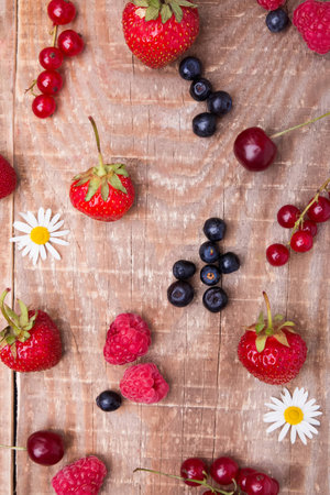 Different berries on the wooden backgroundの写真素材