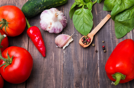 Tomatoes, paprika, basil and garlic on wooden table, ingredients for gazpachoの写真素材
