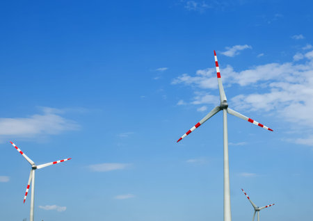 Wind turbines on the blue sky background