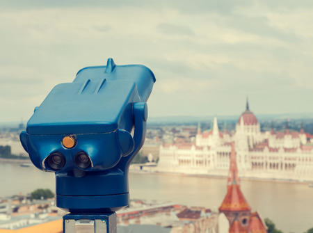 Blue telescope and blurred city on background at Budapest, Hungary. Retro toned photo.の写真素材