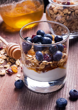 Yougurt with granola in the glass close upの写真素材
