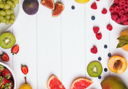 Fruits and berries on the white wooden table, top viewの写真素材