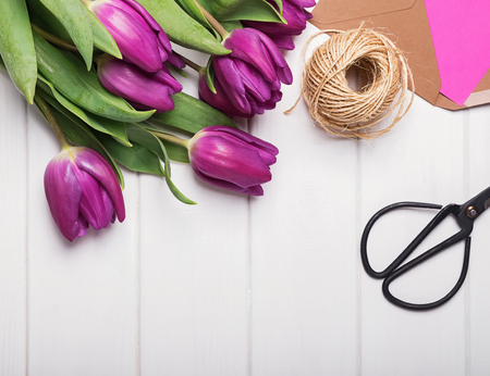 Purple tulips, scissors and jute rope on the white wooden tableの写真素材
