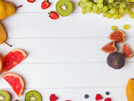 Fruits and berries on the white table, top viewの写真素材