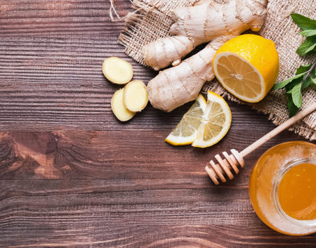 Ingredients for making lemon and ginger tea on wooden background