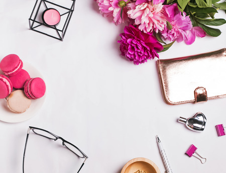Stylish feminine desktop with different cute  accessories and pink peonies, top viewの写真素材