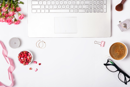 Feminine workplace top view. Laptop and cute small items in the white backgroundの写真素材