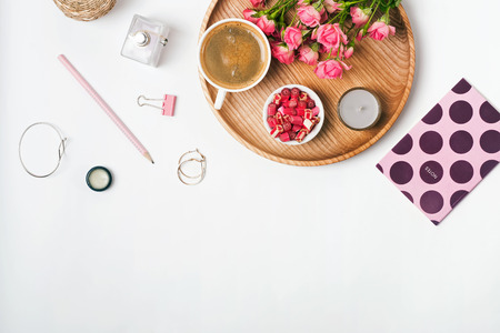Feminine accessories, coffee and roses on the white background, top viewの写真素材