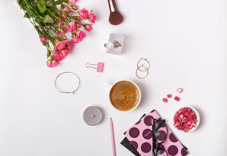Roses, coffe and small stylush feminine accessories on the white backround, top viewの写真素材