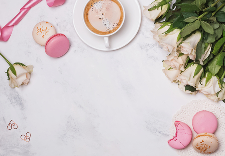 Flat lay with macarons, coffee and rosesの写真素材