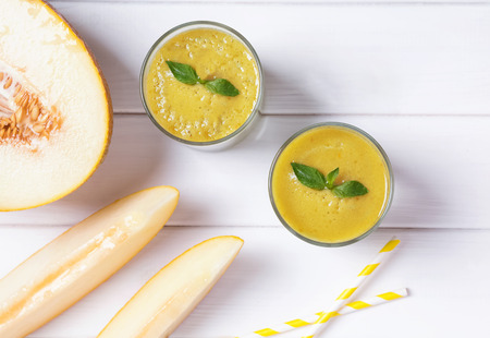 Two glasses with delicious refreshing melon smoothieの写真素材