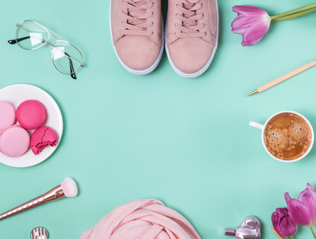 Cute feminine accessories and coffee on the pastel backgroundの写真素材