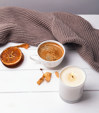 Coffee, candle and knitted sweaterの写真素材
