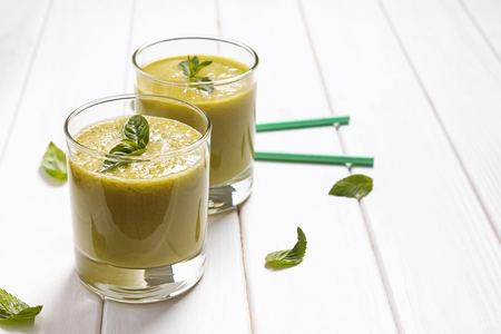 Refreshing green smoothie on the white tableの写真素材