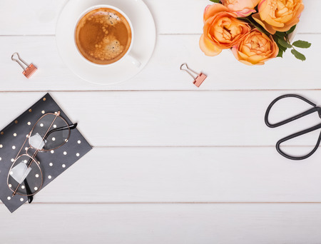 Feminine workplace accessories flat lay. Coffee, glasses ond other, top viewの写真素材
