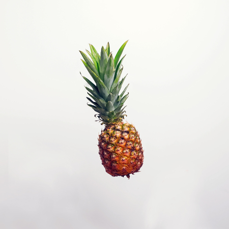 Fresh pineapple in the air. Minimalist summer concept.の写真素材
