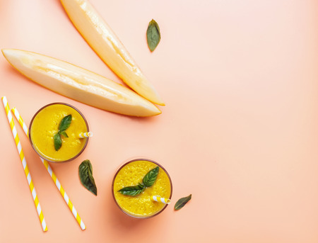 Refreshing melon smoothie with basil on bright background top viewの写真素材