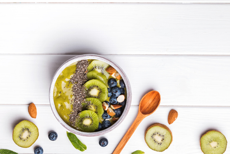 Green smoothie bowl with kiwi, blueberry and chia seeds on the top. Healthy eating.の写真素材