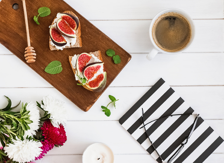 Flat lay with fig toast, coffee and autumn flowersの写真素材