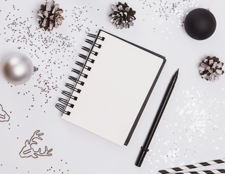 Blank notepad mock-up on the table with modern Christmas decorの写真素材