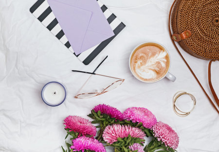 Feminine accessories, flowers and coffee top view