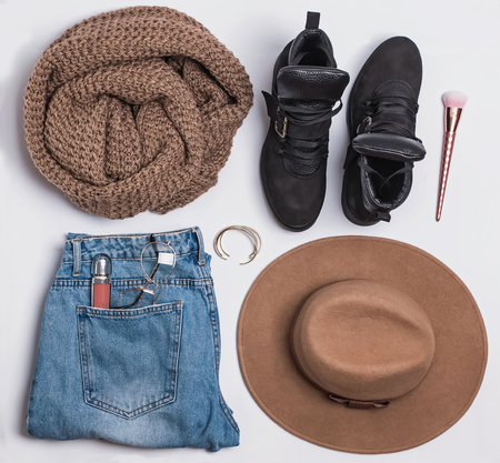 Stylish autumn feminine outfit with boots and sweaterの写真素材