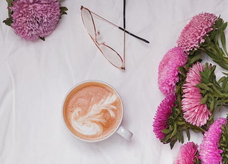 Flowers and coffee on the white backgroundの写真素材