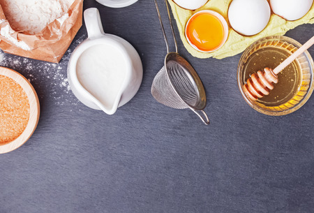 Baking ingredients and tools on the black stone backgroundの写真素材