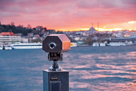 Tourist telescope for watching the city on the sunset.