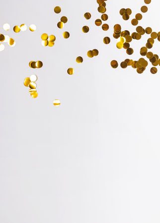 Golden confetti of circle shape on the white backgroundの写真素材