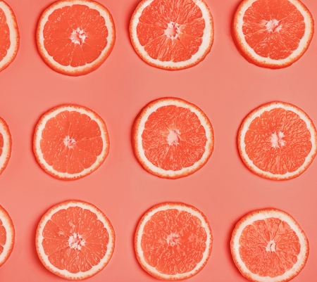 Slices of ripe juicy orange toned in trending coral color.の写真素材