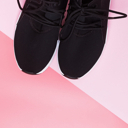 Black sneakers for run or fitness on pink backgroundの写真素材