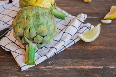 Fresh artichokes on the wooden backgroundの写真素材