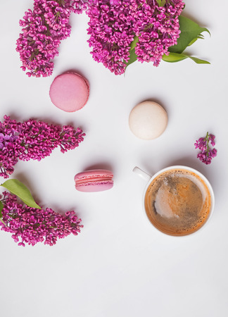 Creative spring composition with coffee, macarons and lilac flowersの写真素材