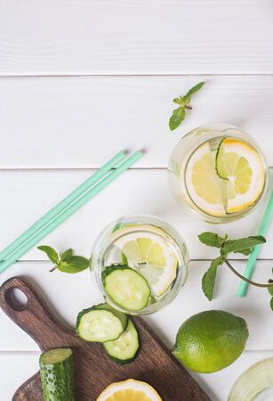 Water infused with mint, lemon and cucucmber on the white wooden tableの写真素材