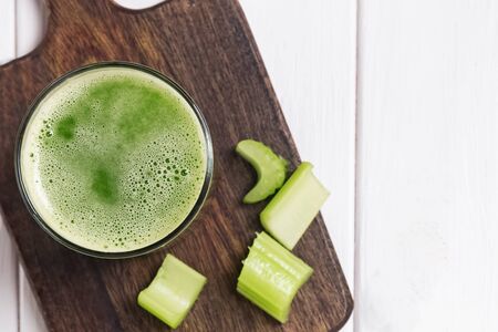 Healthy detox celery juice in a glass on the white tableの写真素材