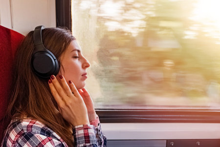 Young woman in headphones enjoying calm music in headphones