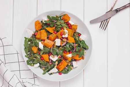 Delicious seasonal salad with pumkin or squash, arugula and feta cheeseの写真素材