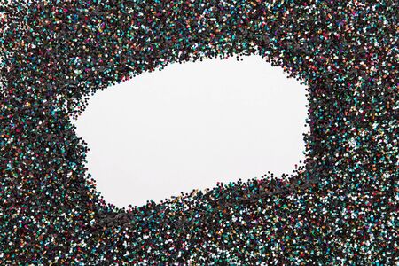 Holographic glitter on black background with empty blank space in the center. Creative festive frame.の写真素材