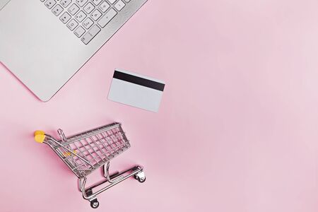 Laptop, credit card and small shopping trolley , top view.の写真素材