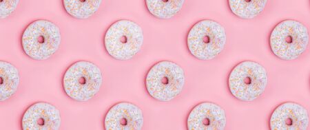 Creative background with delicious glazed donutsの写真素材