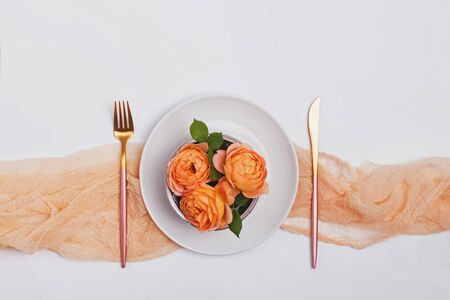 Creative tablesetting for date or wedding decorated with beautiful roses, top viewの写真素材