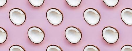 Coconut halves on pink backgound.の写真素材