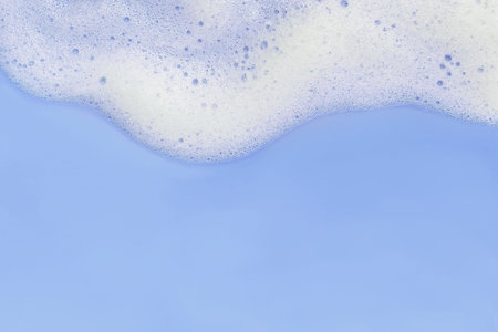 White foam on pastel blue background with copy spaceの写真素材