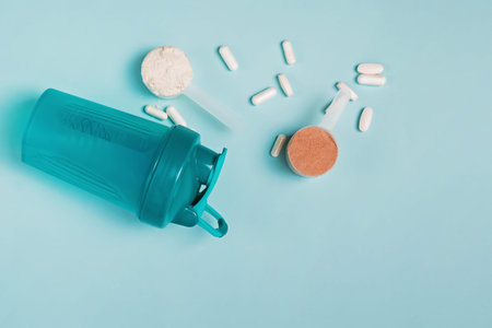 Scoops of chocolate and vanilla whey isolate protein, shaker and other sport nutrition supplements...