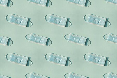Pattern of Medical mask on blue background, flat lay top viewの写真素材