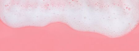 White soap foam on pink background, banner formatの写真素材