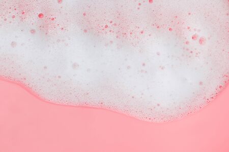 White soap foam on pink backgroundの写真素材