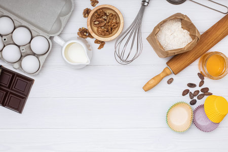 Ingredients and utensil for baking on white background, top view