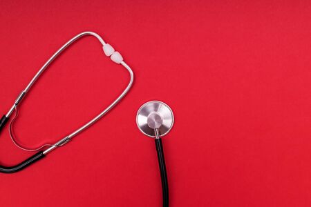 Stethoscope or phonendoscope isolated on red background.の写真素材